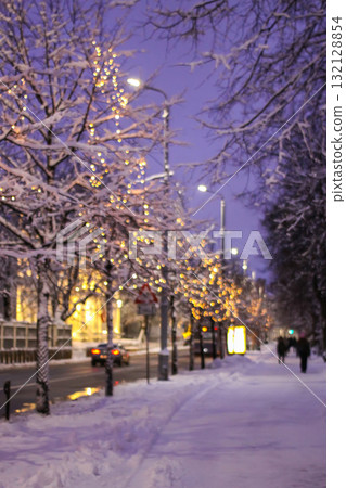 Snow-covered street with festive lights in Riga, Latvia. Snow-covered street with festive lights in Riga, Latvia. 132128854