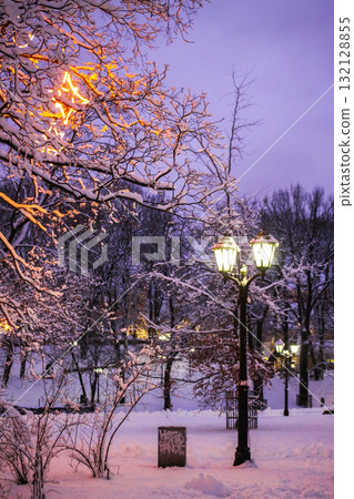 Snow-covered street with festive lights in Riga, Latvia. Snow-covered street with festive lights in Riga, Latvia. 132128855