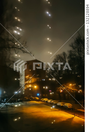 Twinkling fairy lights on window creating warm holiday atmosphere. Twinkling fairy lights on window creating warm holiday atmosphere. 132128894