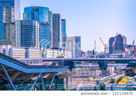 Tokyo cityscape in Japan. View of Shinagawa Station, office buildings, trains, etc. Takanawa Gateway Station is in the foreground. 132129470