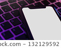 Mock up, smartphone with white blank screen lying on laptop keyboard 132129592