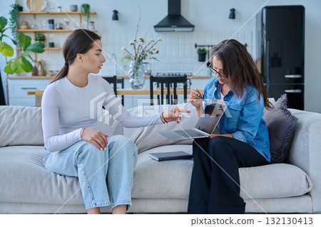 Female social worker working at home with teenage girl Female social worker working at home with teenage girl 132130413