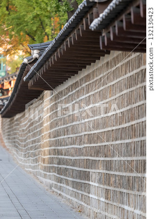 Deoksugung Stonewall Walkway with beautiful autumn foliage. It is the pedestrian footpath that runs next to Deoksugung Palace in Seoul, South Korea Deoksugung Stonewall Walkway with beautiful autumn foliage. It is the pedestrian footpath that runs next to Deoksugung Palace in Seoul, South Korea 132130423