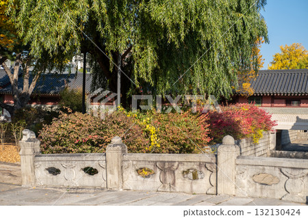 Bridge and Korean traditional building in Changdeokgung palace in Seoul, South Korea. It is one of the Five Grand Palaces built by the kings of the Joseon dynasty. with beautiful autumn foliage. 132130424