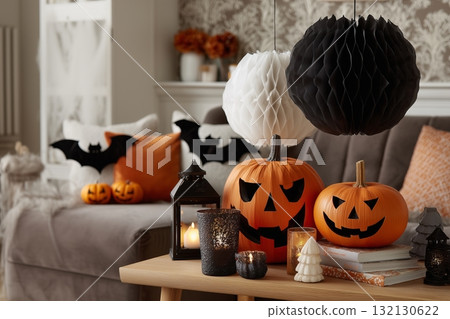 Festive Halloween decorations with carved pumpkins, lanterns, and themed ornaments in cozy living room Festive Halloween decorations with carved pumpkins, lanterns, and themed ornaments in cozy living room 132130622