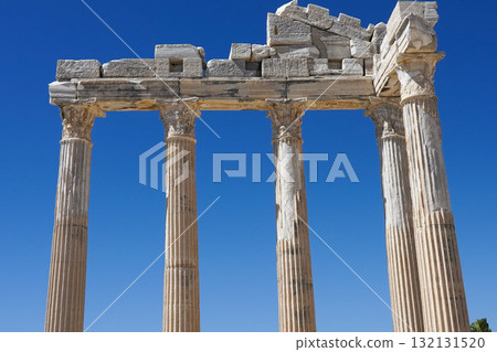 Ancient Ruins of a Classical Temple Surrounded by a Clear Blue Sky, Showcasing Stunning Architectural Details and Historical Significance of Ancient Civilizations 132131520