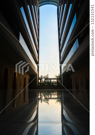 A Serene Reflection of Modern Architecture Captured in the Tranquil Hallway Framing a Beautiful Sky and Lush Greenery Amidst Brilliant Glass Structures A Serene Reflection of Modern Architecture Captured in the Tranquil Hallway Framing a Beautiful Sky and Lush Greenery Amidst Brilliant Glass Structures 132131541