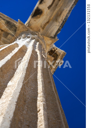 An Architectural Marvel: Capturing the Majestic Details of an Ancient Column Set Against a Clear Blue Sky An Architectural Marvel: Capturing the Majestic Details of an Ancient Column Set Against a Clear Blue Sky 132131558