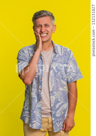 Adult man touching cheek with painful expression suffering from strong toothache dental discomfort 132131827