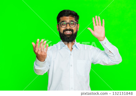 Indian man waving hand hello welcome fast inviting come here gesture smiling attracting attention Indian man waving hand hello welcome fast inviting come here gesture smiling attracting attention 132131848