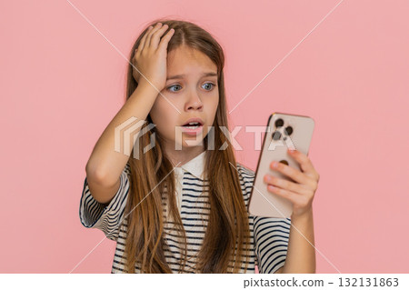 Child girl kid sadly playing mobile online game on smartphone disappointed by lottery game defeat 132131863