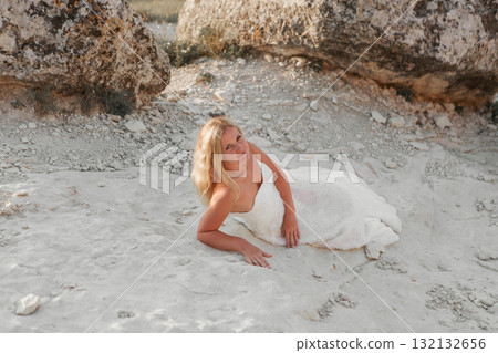 a woman in a white dress, a bride on a mountain with a blue sky. Beautiful nature, freedom, enjoyment of life. High quality photo a woman in a white dress, a bride on a mountain with a blue sky. Beautiful nature, freedom, enjoyment of life. High quality photo 132132656