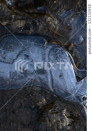 frozen piece of ice on the ground. autumn frosts are the first frosts. 132132658