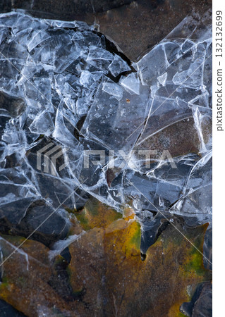 broken piece of ice on the ground. autumn frosts are the first frosts broken piece of ice on the ground. autumn frosts are the first frosts 132132699