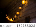 Horizontal photo of glowing warm lights on a brick wall creating a cozy and festive atmosphere. Perfect for home decor, comfort, and interior inspiration 132133028