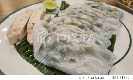Vietnamese steamed rice rolls with herbs and dipping sauce on plate Vietnamese steamed rice rolls with herbs and dipping sauce on plate 132133832