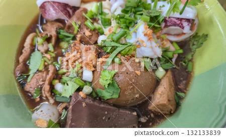 Vietnamese Rice Noodle Soup and fresh herbs in green bowl Vietnamese Rice Noodle Soup and fresh herbs in green bowl 132133839