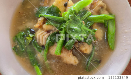 stir-fried rice noodle with gravy and fish on plate 132133849