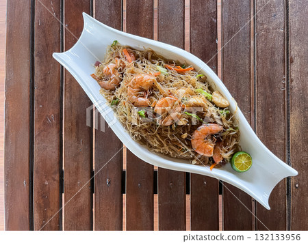 Pansit Canton Bihon, Filipino rice and egg noodles with vegetables, meat, and seafood, served with shrimp and calamansi 132133956