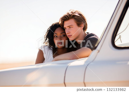 Young couple leaning on a white vehicle, sharing a calm and intimate moment in soft natural light with a warm atmosphere 132133982