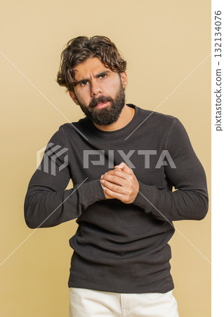 Lebanese young man stress tension rage problems surprise shock feels horror against beige background 132134076
