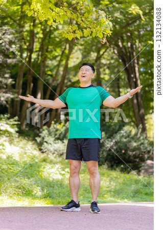 Sporty Asian man practicing yoga meditation receives positive energy healthy breath exercises 132134088