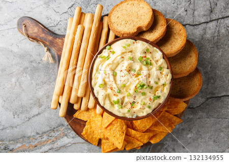 Deviled Egg Dip festive buffet appetizer with chips, breadsticks and biscuit close-up in a plate. Horizontal top view 132134955