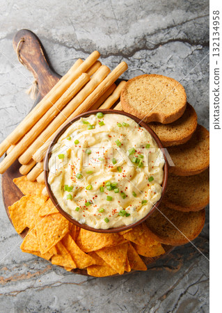 creamy, punchy egg dip that really tastes just like a deviled egg with bread close-up in a plate. Vertical top view 132134958
