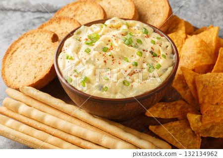 Deviled Egg Dip festive buffet appetizer with chips, breadsticks and biscuit close-up in a plate. Horizontal Deviled Egg Dip festive buffet appetizer with chips, breadsticks and biscuit close-up in a plate. Horizontal 132134962