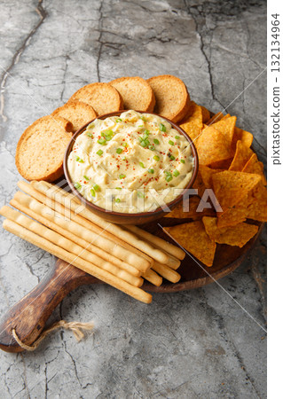creamy, punchy egg dip that really tastes just like a deviled egg with bread close-up in a plate. Vertical 132134964