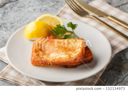 Saganaki authentic Greek cheese appetizer close-up in a plate. Horizontal Saganaki authentic Greek cheese appetizer close-up in a plate. Horizontal 132134973