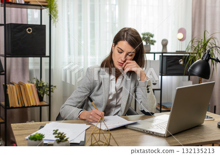 Business busy woman thinking about an important creative project work laptop decision at home office 132135213