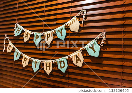 Happy Birthday garland on wooden blinds 132136495