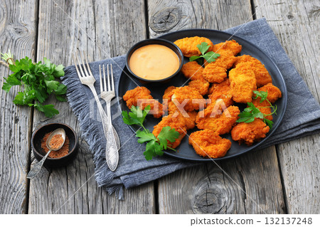 breaded chicken breast chunks with dipping sauce 132137248
