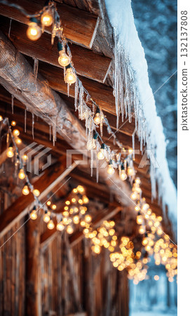 Twinkling lights hang from the eaves of a rustic cabin, creating a warm atmosphere against the snowy backdrop of a winter landscape, inviting a sense of coziness and cheer 132137808