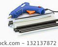 Hot Glue Gun with Black and White Glue Sticks on White Background 132137872