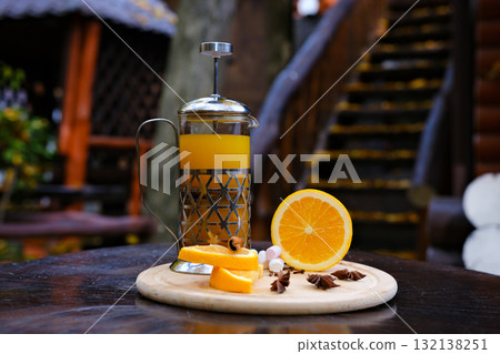 French press oranges Artisanal tea in a clear French press, infused with vibrant orange and refreshing mint, set against a stylish black and beige color-block backdrop. French press oranges Artisanal tea in a clear French press, infused with vibrant orange and refreshing mint, set against a stylish black and beige color-block backdrop. 132138251