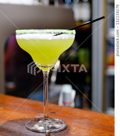 Spicy margarita summer cocktail drink with silver tequila, lime juice, syrup, mint and ice in glass with salted pepper rim, dark background Spicy margarita summer cocktail drink with silver tequila, lime juice, syrup, mint and ice in glass with salted pepper rim, dark background 132138276
