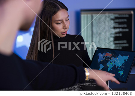 Cybersecurity professionals collaborating on real-time threat analysis in a SOC environment 132138408