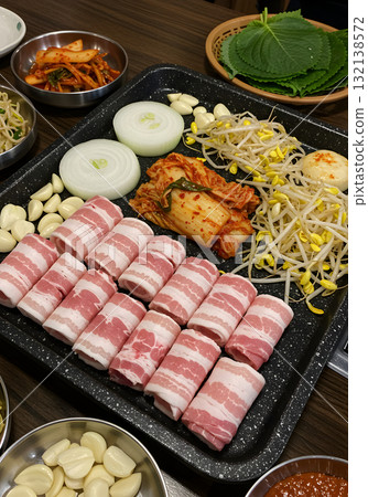 Korean BBQ Pork Belly (Samgyeopsal) with Kimchi and Sides on Grill Pan 132138572