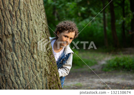 Boy face lights up with excitement as he found something interesting in park. Captures spontaneous moment of discovery and pure unfiltered joy Boy face lights up with excitement as he found something interesting in park. Captures spontaneous moment of discovery and pure unfiltered joy 132138674
