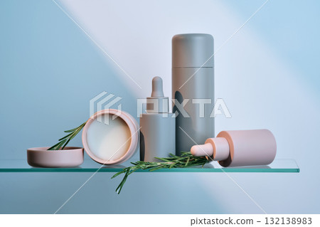 A composition of cosmetic care products on a glass shelf. A composition of cosmetic care products on a glass shelf. 132138983