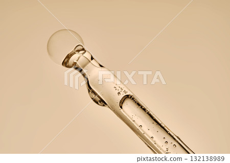 The texture of the hyaluronic serum flowing down the dropper. 132138989