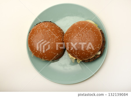 Hamburger with meat and vegetables. Fast food. Hamburger on a plate. Hamburger with meat and vegetables. Fast food. Hamburger on a plate. 132139084
