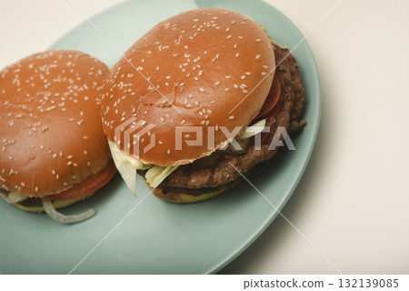Hamburger with meat and vegetables. Fast food. Hamburger on a plate. Hamburger with meat and vegetables. Fast food. Hamburger on a plate. 132139085