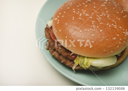 Hamburger with meat and vegetables. Fast food. Hamburger on a plate. Hamburger with meat and vegetables. Fast food. Hamburger on a plate. 132139086