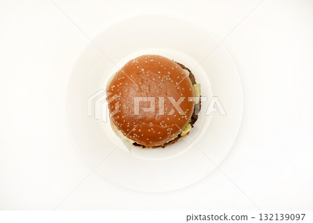 Hamburger with meat and vegetables. Fast food. Hamburger on a plate. 132139097