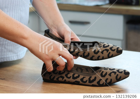 Woman unboxing and reviewing leopard print shoes Summer boat shoes 132139206