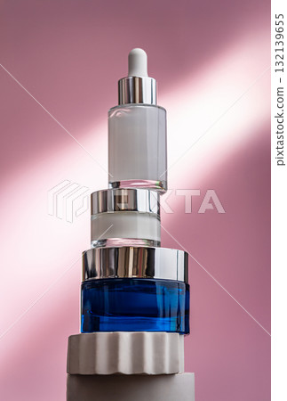 Skincare composition with serum and moisturizing creams on pink background 132139655