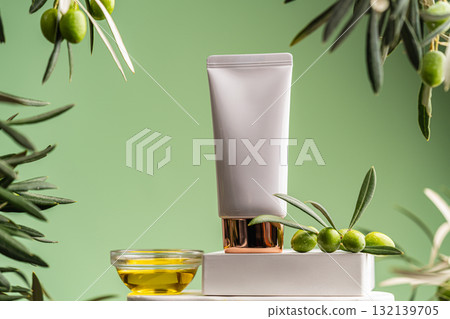 Sunscreen tube with olive branches and olive oil on green background, natural skincare concept 132139705